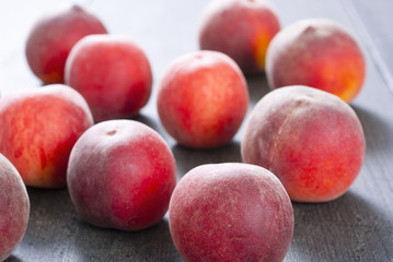 ripe homegrown peaches on black wooden table