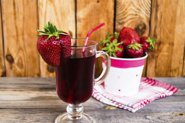 strawberry juice and fresh strawberries in a glass cup