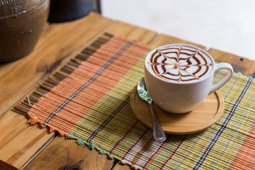 Cappuccino cup on bar table near window in the restaurant