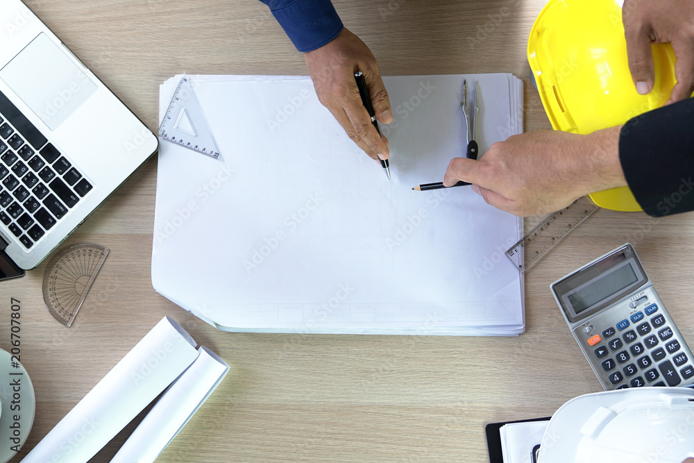 Poster flat lay of top view desk work table architect with drawing home plan building and stationary in hom