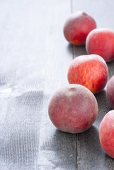 ripe homegrown peaches on black wooden table