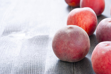 ripe homegrown peaches on black wooden table
