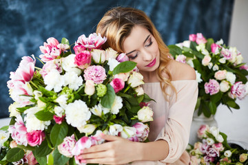 Beautiful young woman with make-up and curls. The girl's face is in flowers.