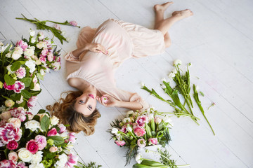 Beautiful young woman with make-up and curls. The girl's face is in flowers.