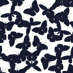 Seamless pattern of chaotic butterflies on a white background. Vector illustration.
