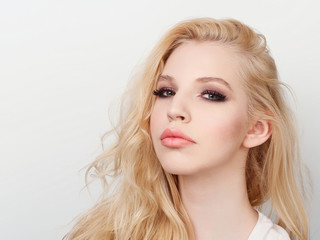Beauty portrait of model with trendy natural make-up. Fashion shiny highlighter on skin, sexy gloss lips make-up.