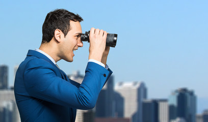 Fototapeta na wymiar Businessman looking through binoculars