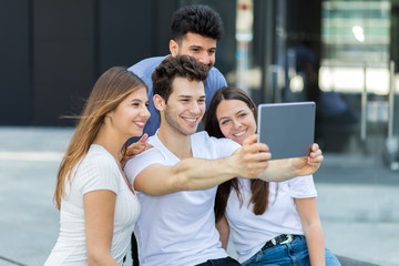 Fototapeta premium Group of friends taking selfie with a tablet