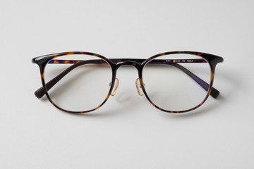 Front view of reading glasses with tortoiseshell frames on white background