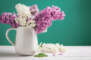 Floral pattern lilac branches and petals on wooden background. Frame.