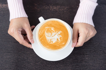 Woman drinking hot latte coffee.