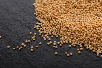 fresh amaranth grains on a rustic background