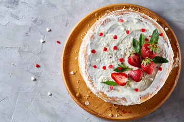 Tart with strawberries and whipped cream decorated with mint leaves on white textured background, selective focus
