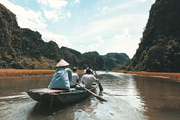 Tourists traveling in boat along the Ngo Dong River. Tam Coc, Ninh Binh, Vietnam