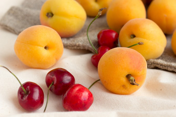 Naklejka na ściany i meble Apricots, Cherries on burlap sack