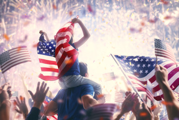 People holding the Flags of the USA. - Powered by Adobe