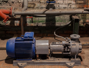 Blue and gray electrical engine in the old vintage boiler room