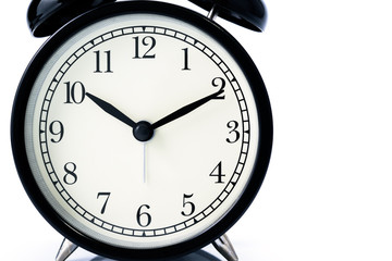 Close up of black alarm clock isolated on white background