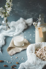 Vegan non-dairy almond milk in glass bottles on wooden background