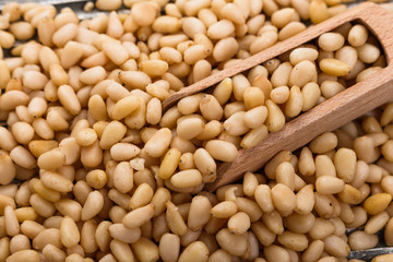 peeled pine nuts on a rustic background