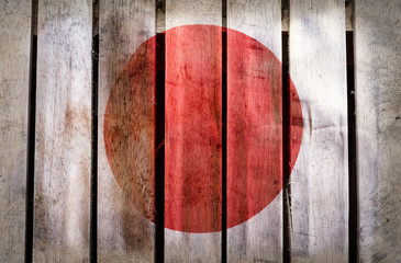 Grunge filtered,Japan national flag on wooden background.