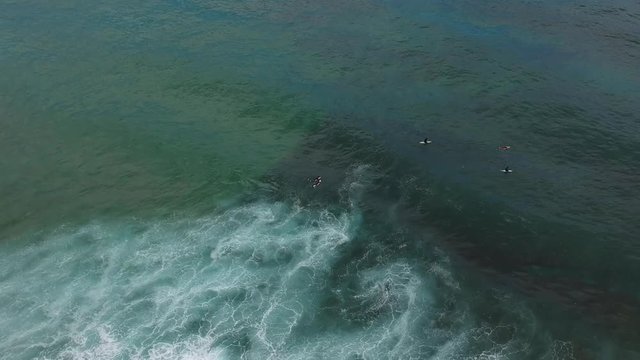 Aerial view from a surf spot with waves and a group of surfers in Ericeira, Portugal