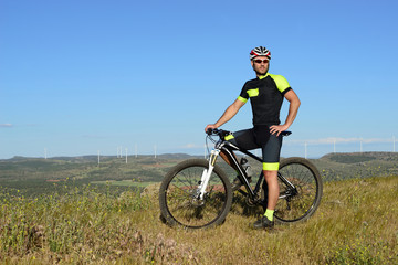 Obraz na płótnie Canvas Young sportsman with his mountain bike.