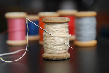 Close up Rolls of Vintage Colorful Threads. Clothes Repair, Black Dark Background. Sewing work process