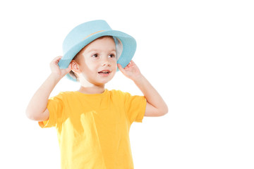 Little caucasian boy in hat is dancing, isolated white. Little cute cheerful humor kid is dancing on white background.