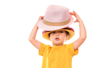 Little caucasian boy in hat is dancing, isolated white. Little cute cheerful humor kid is dancing on white background.
