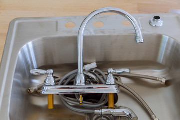 installing a stainless steel kitchen sink.