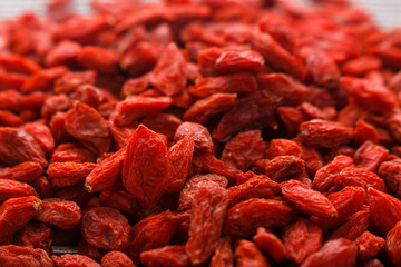 dried goji berries on a wooden rustic background