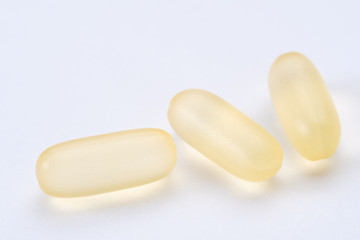 Fototapeta na wymiar yellow white pills capsule isolated on white background