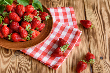 Tasty strawberry on a wooden table. It can be used as a background