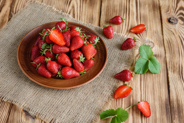 Tasty strawberry on a wooden table. It can be used as a background