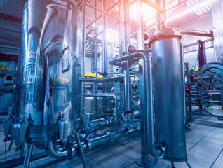 Modern interior of a brewery. Barrels and pipes. Factory interior.