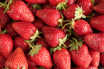 Tasty strawberry on a wooden table. It can be used as a background