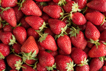 Tasty strawberry on a wooden table. It can be used as a background