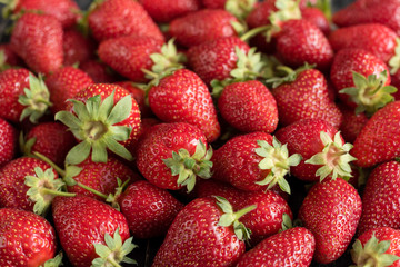 Tasty strawberry on a wooden table. It can be used as a background
