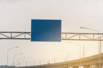 Blue overhead road sign with space to enter text. cloudy sky background. Copy space.