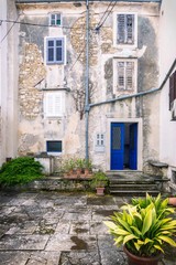 Fototapeta na wymiar Facade with entrance door and windows of an old house in the city of Motovun on Istria in Croatia, Europe.