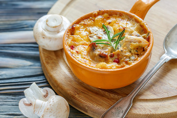 Clay pot with fried mushrooms,chicken and cheese.