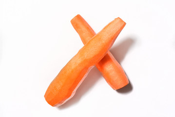 Fresh, peeled carrots lie on a cutting board. Close-up