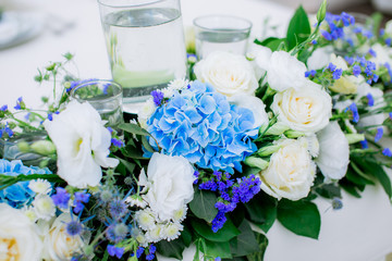 wedding bouquet from different colors of blue and pink white and yellow in a vase
