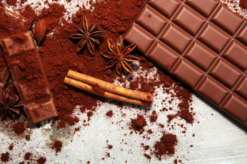 Chocolate bars on table with chocolate powder.