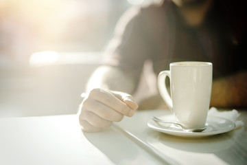 Young attractive man drinking coffee at lunch time