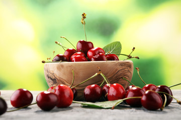 Cherry. Red fresh Cherries in bowl and a bunch of cherries on the table