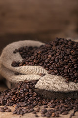 Fototapeta premium Sack of spilled roasted coffee beans