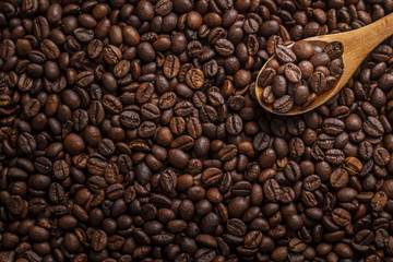 Wooden spoon with roasted coffee beans