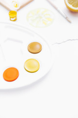 Creative flat lay art workspace with yellow palettes, paint brushes,. Artist background